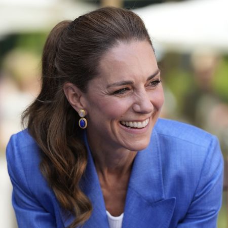 Princess Kate smiling in a blue suit