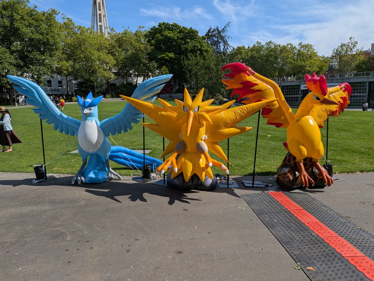 Three inflatable Pok&eacute;mon at a park
