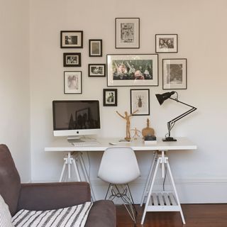 modern white living room with desk and artwork