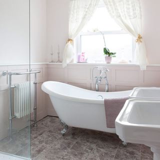 bathroom with tiled flooring and white bathtub