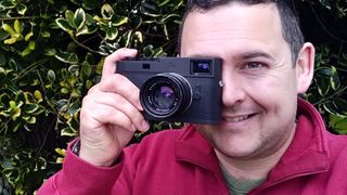 Sebastian Oakley holding a leica M11-D p to his eye