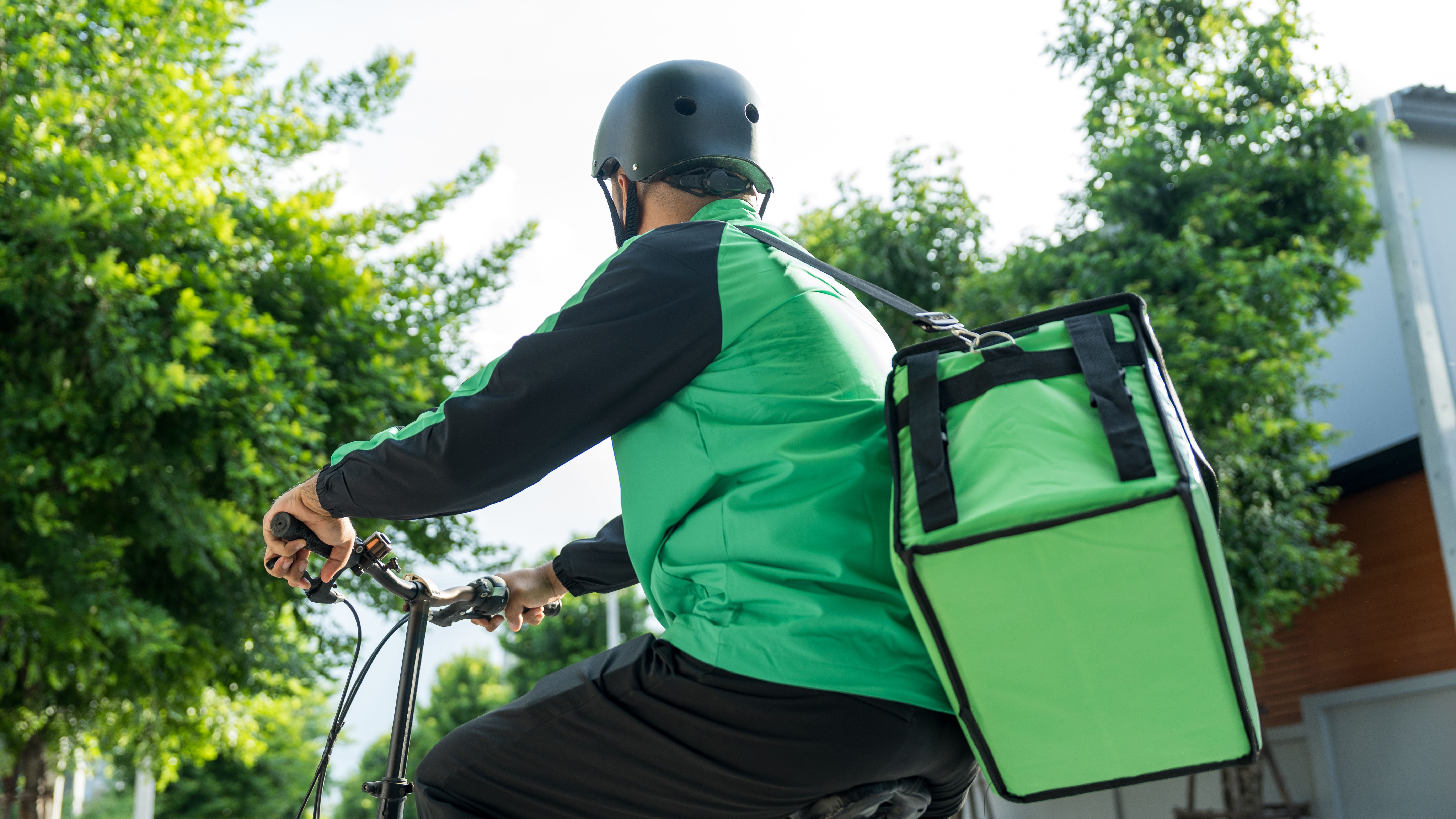 Man on a bike with a food delivery.