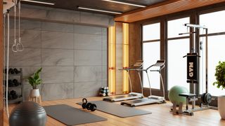 A modern, spacious gym with treadmills, yoga mats, and weights.