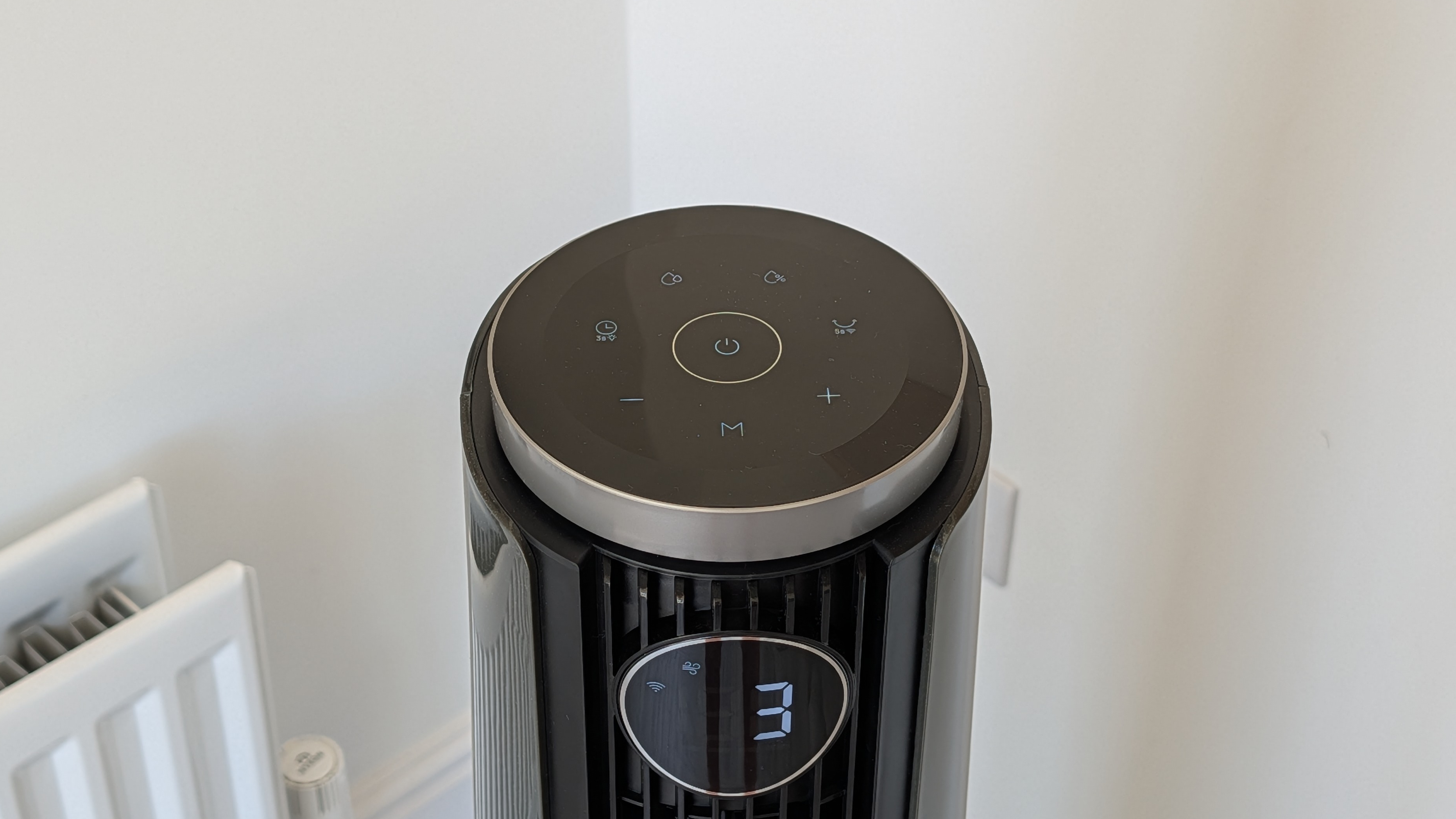 A closeup of the Dreo Smart Misting Fan 765S showing its controls, featuring symbols for humidity, timers, rotating, plus and minus and misting.