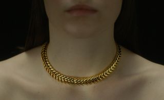 woman wearing chain necklace, among exhibits at Ukrainian Creators Fair