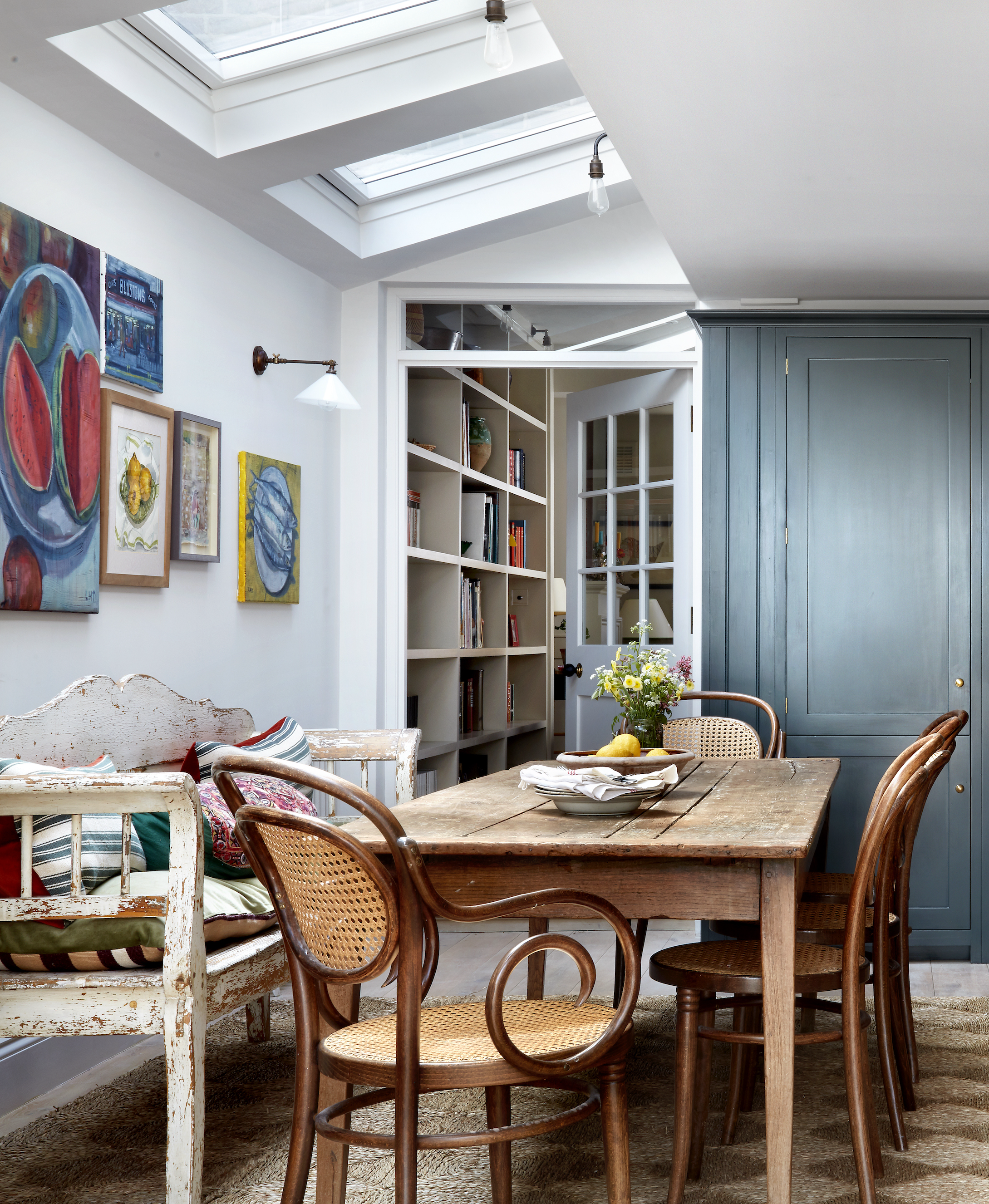 Vintage dining table paired with an antique bench and chairs
