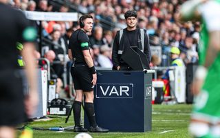 Referee Matthew MacDermid speaks to a Hawk-Eye representative as there is a break in play as VAR is non-operational during a William Hill Premiership match between St Mirren and Hibernian at the SMiSA Stadium, on August 04, 2024, in Paisley, Scotland