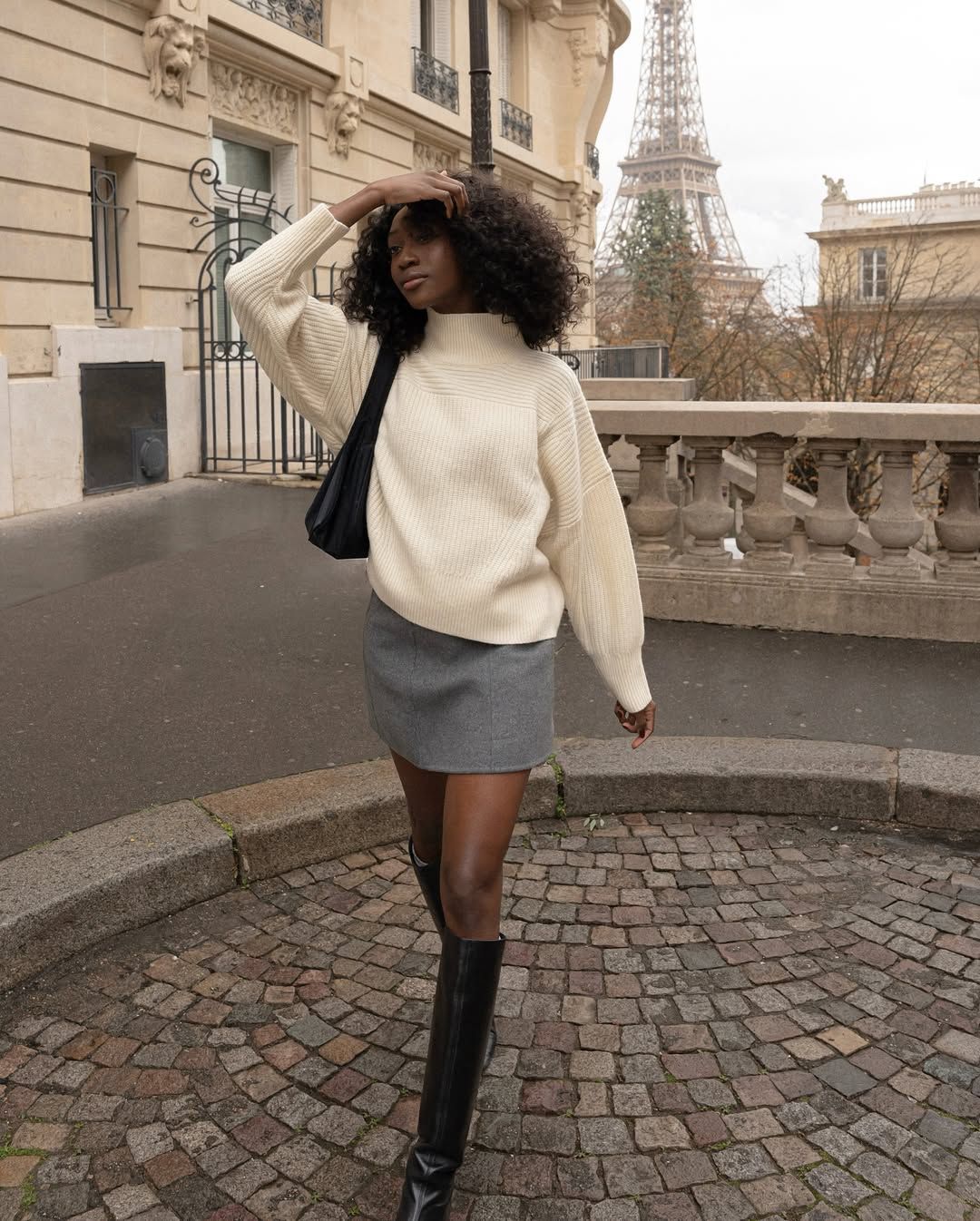 @emmanuellek wearing a mini skirt, jumper and boots