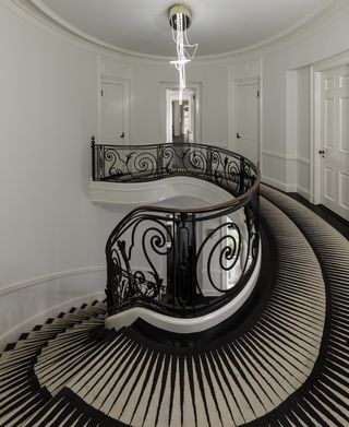 A round staircase with a runner