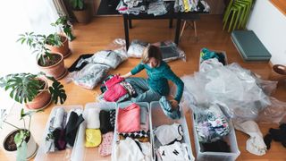 Woman with clothes in boxes