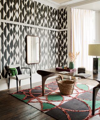 Home office with pattern clash wallpaper and rug