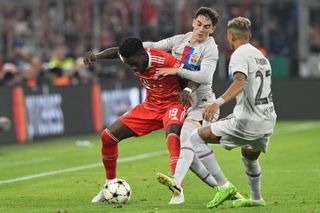 Bayern Munich's Canadian midfielder Alphonso Davies, Barcelona's Spanish midfielder Gavi and Barcelona's Brazilian forward Raphinha vie for the ball during the UEFA Champions League Group C football match between FC Bayern Munich and FC Barcelona in Munich, southern Germany on September 13, 2022.
