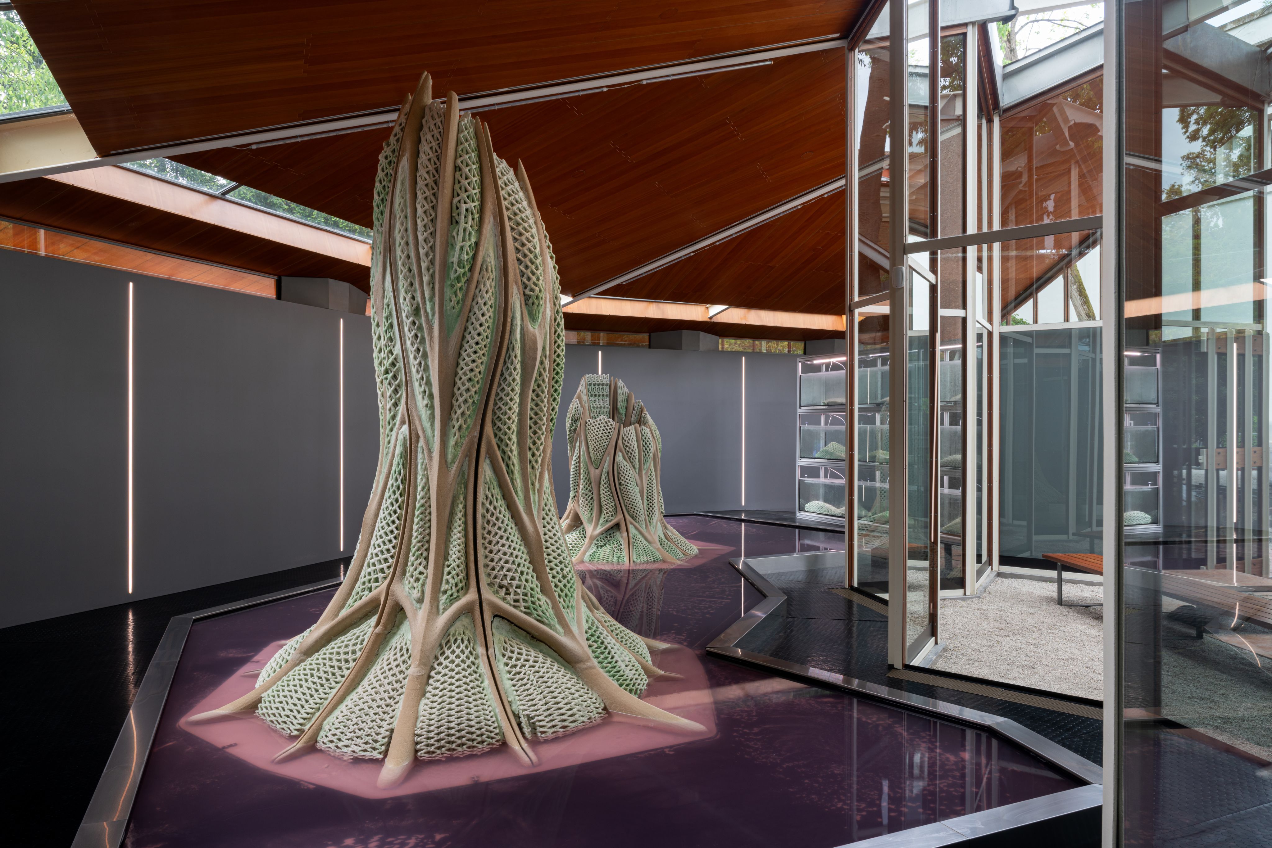 A tree trunk-like object incorporating a new living material at an architecture exhibition in Venice.