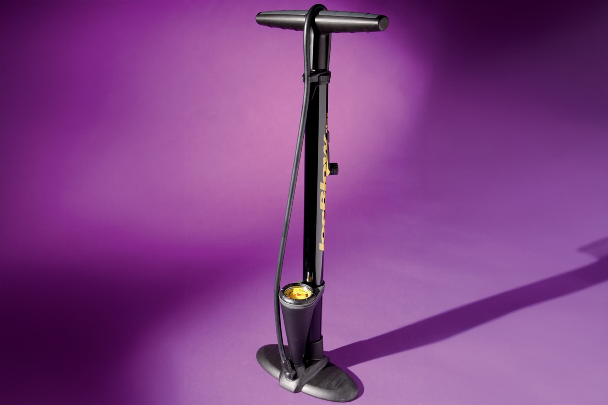Topeak JoeBlow Max II in black with their trademark yellow logos, set to a purple background