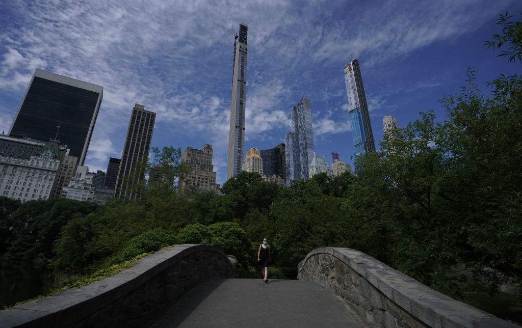 A woman walks across a bridge in New York&amp;#039;s Central Park.