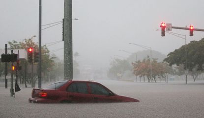 Car in Hawaii flooded by Hurricane Lane's rain.