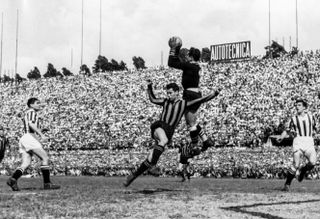 Juventus goalkeeper Lucidio Sentimenti makes a save in a game against Inter in 1946.