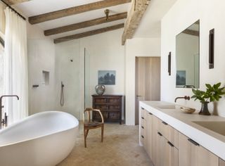 A bathroom with tactile walls and wooden beams