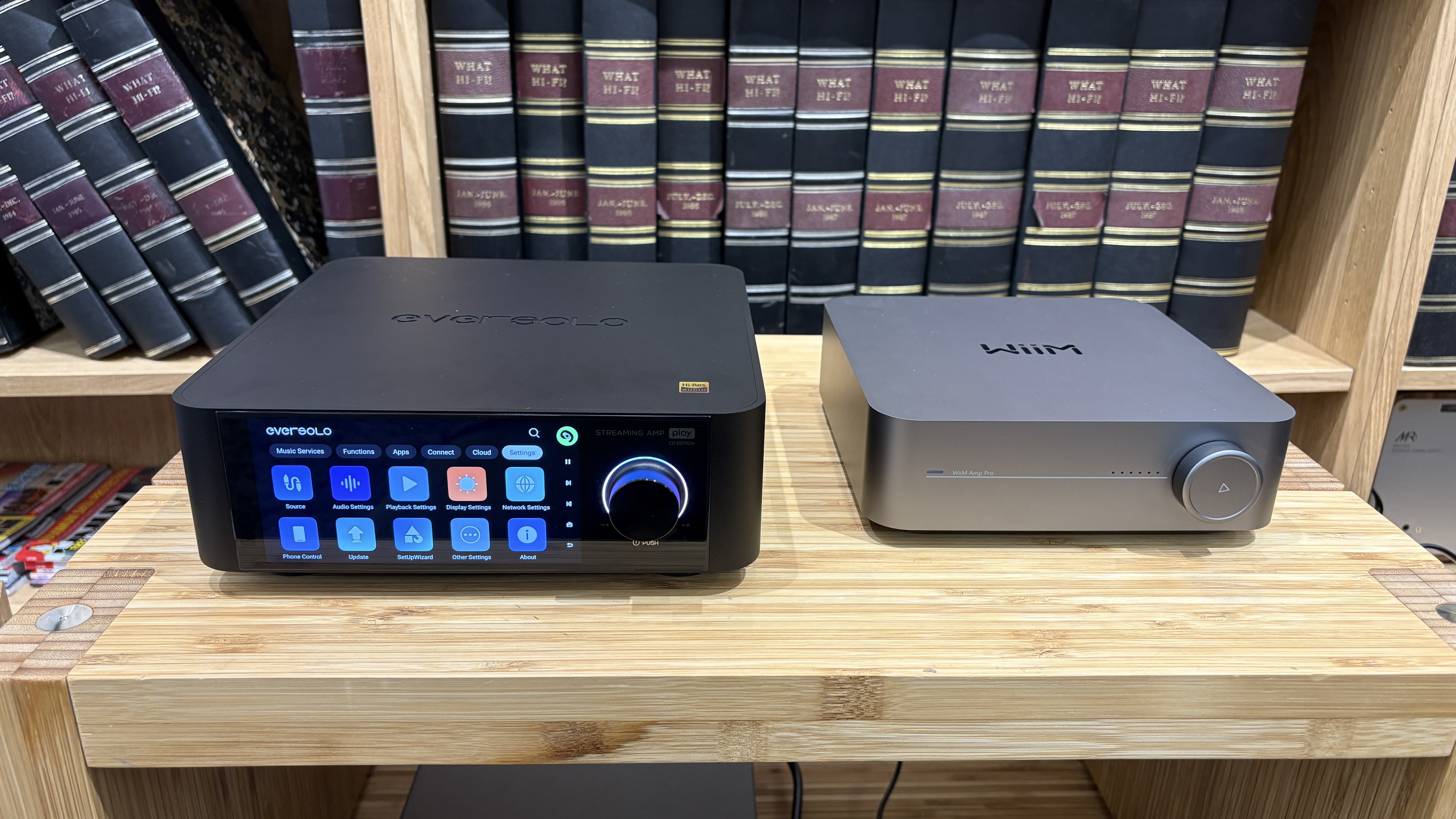 Eversolo Play CD Edition and WiiM Amp Pro placed side-by-side on wooden rack