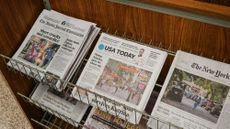 A row of newspapers are seen on a stand in Atlanta, Georgia. 