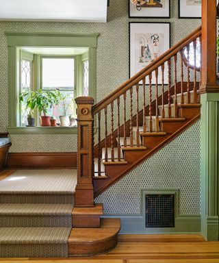 Stairs in green wallpapered entryway