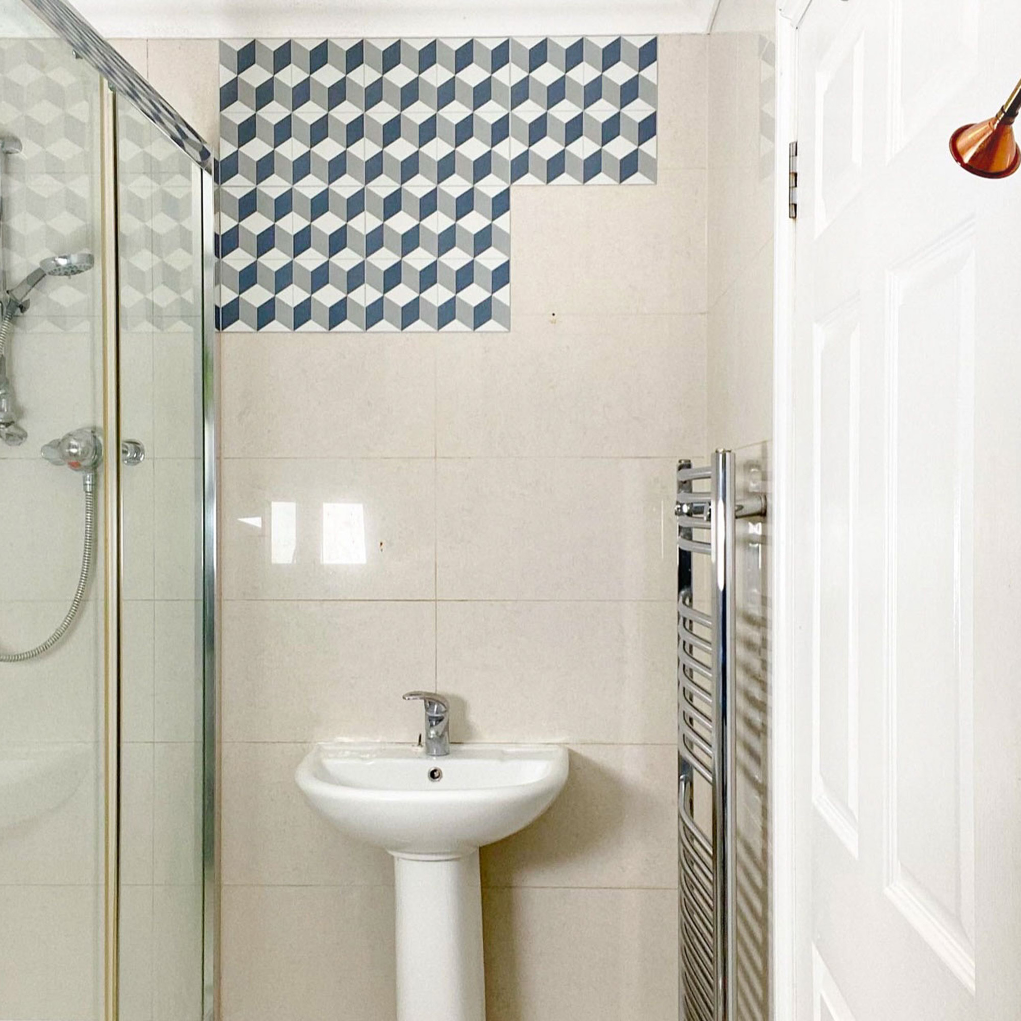 bathroom makeover with half the wall covered in patterned tiles