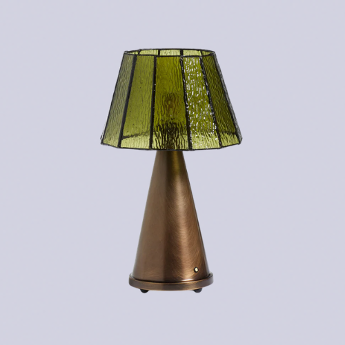 A table lamp with a brass base and a green glass shade