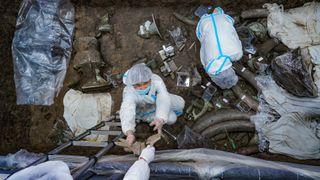 Archaeologists excavate one of the pits at Sanxingdui in China.