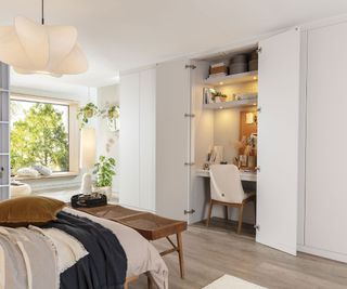 bedroom with fitted wardrobes and desk