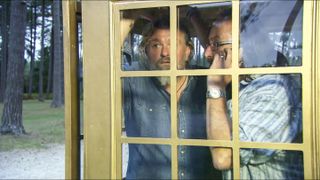 A still of Si King and Dave Myers in a yellow phone box from The Hairy Bikers Christmas Party.