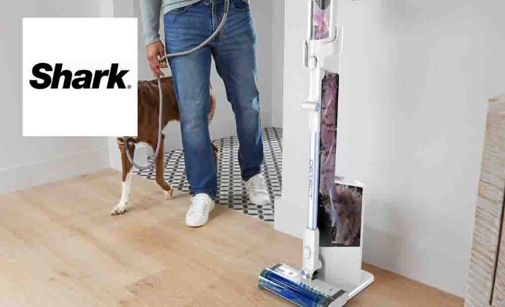 Shark logo placed over a man with his dog walking into a room with a shark pet vaccum 
