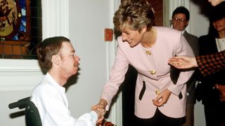 Princess Diana shakes hands with an AIDS patient