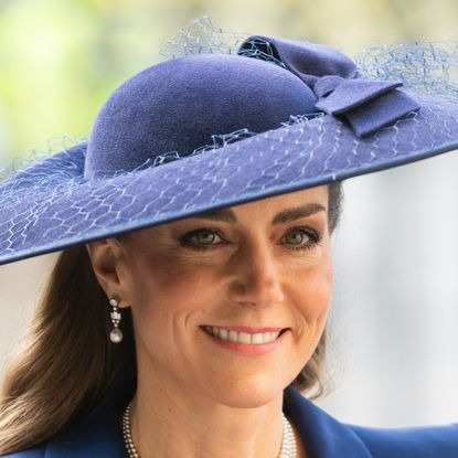 Princess Kate wearing a blue hat and coat