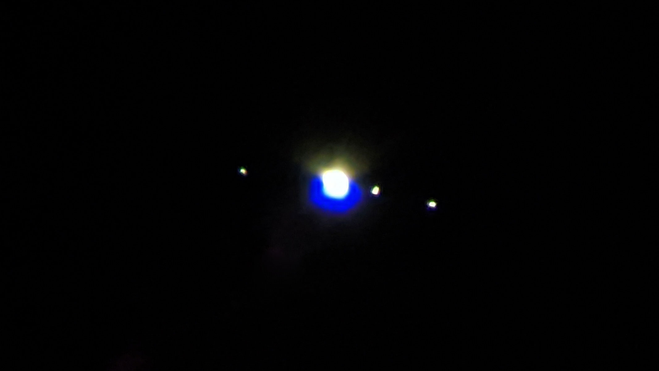 Jupiter and four of its moons as viewed through the binoculars