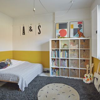kids bedroom with white and yellow walls and book shelves