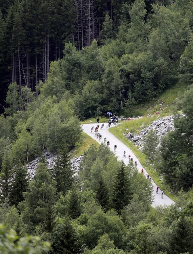 The Tour de France peloton makes its way from Bourg d'Oisans to Le Grand Bornand in stage 19