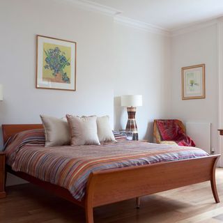 Bedroom with white walls and wooden flooring