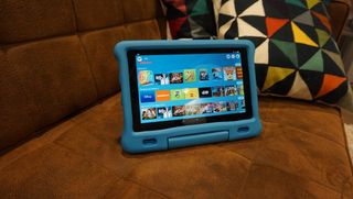 The Amazon Fire HD 10 Kids' Edition on a sofa
