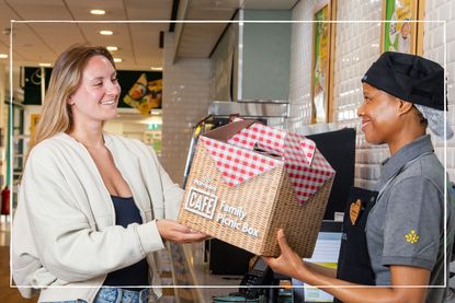 Morrisons&#039; Family Picnic Box being handed to a woman in a Morrisons Cafe