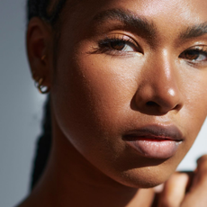 Black woman looking into the camera.