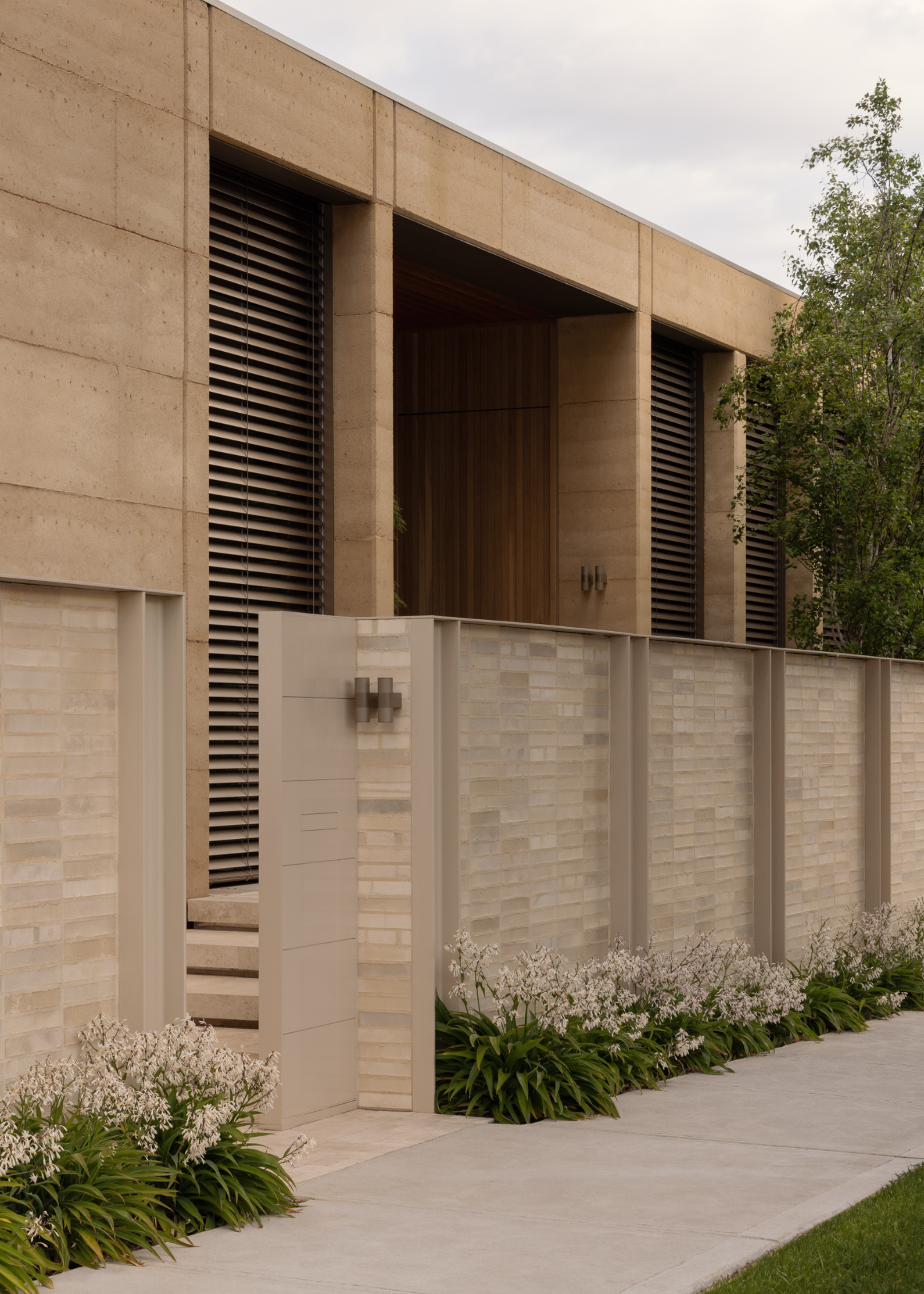 A front garden with textured plants lining the border