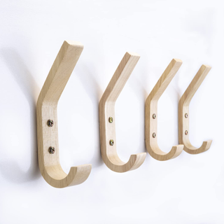 A set of four wooden wall-mounted storage hooks.