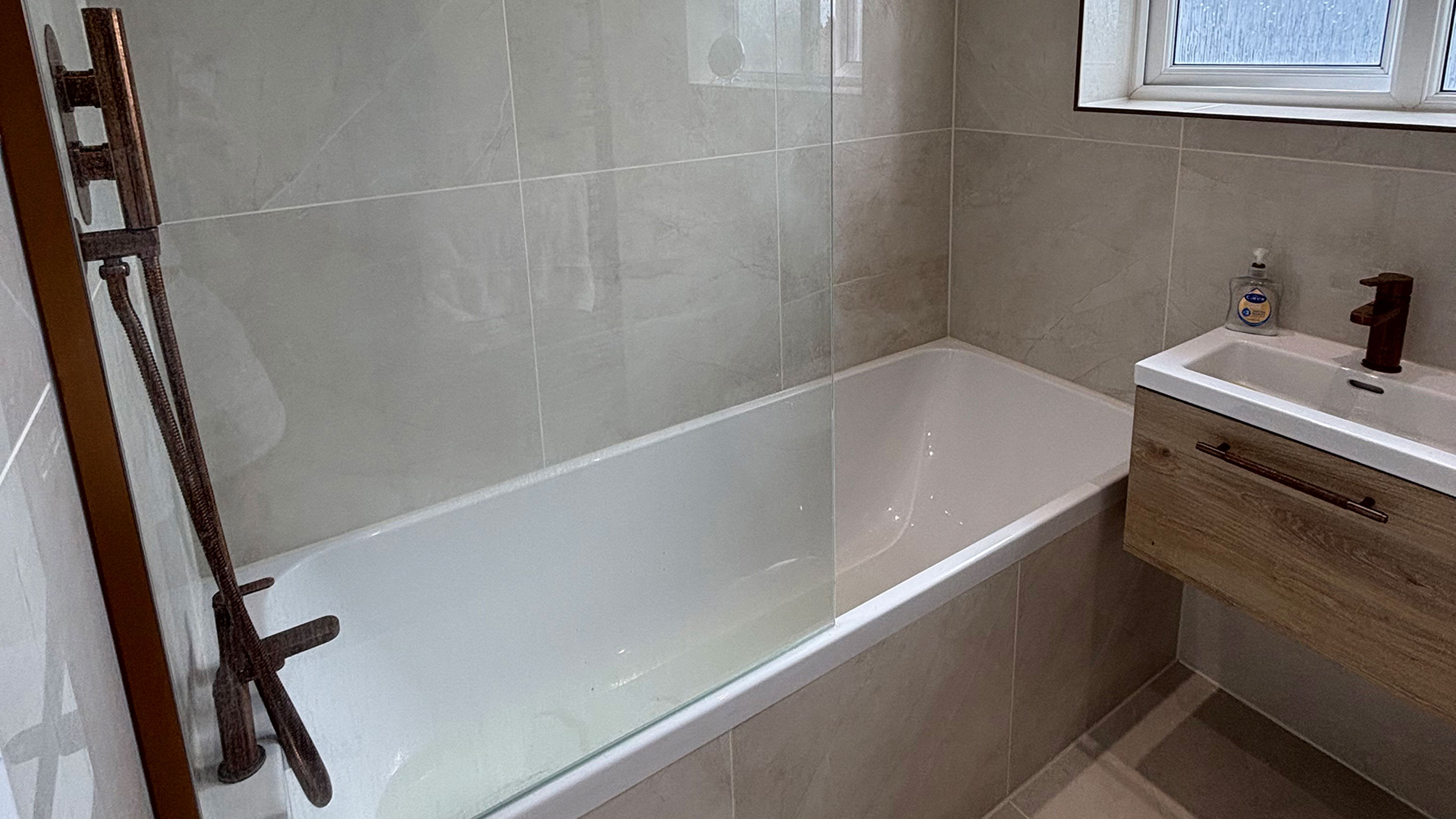Grey bathroom with large format tiles on floor and walls