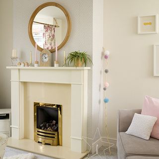 living room with fire place and oval mirror