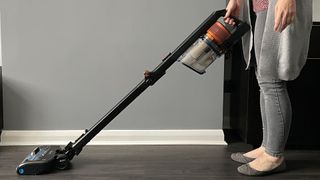 Reviewer testing the Shark Vertex Pro / Anti Hair Wrap cordless stick vacuum in her home