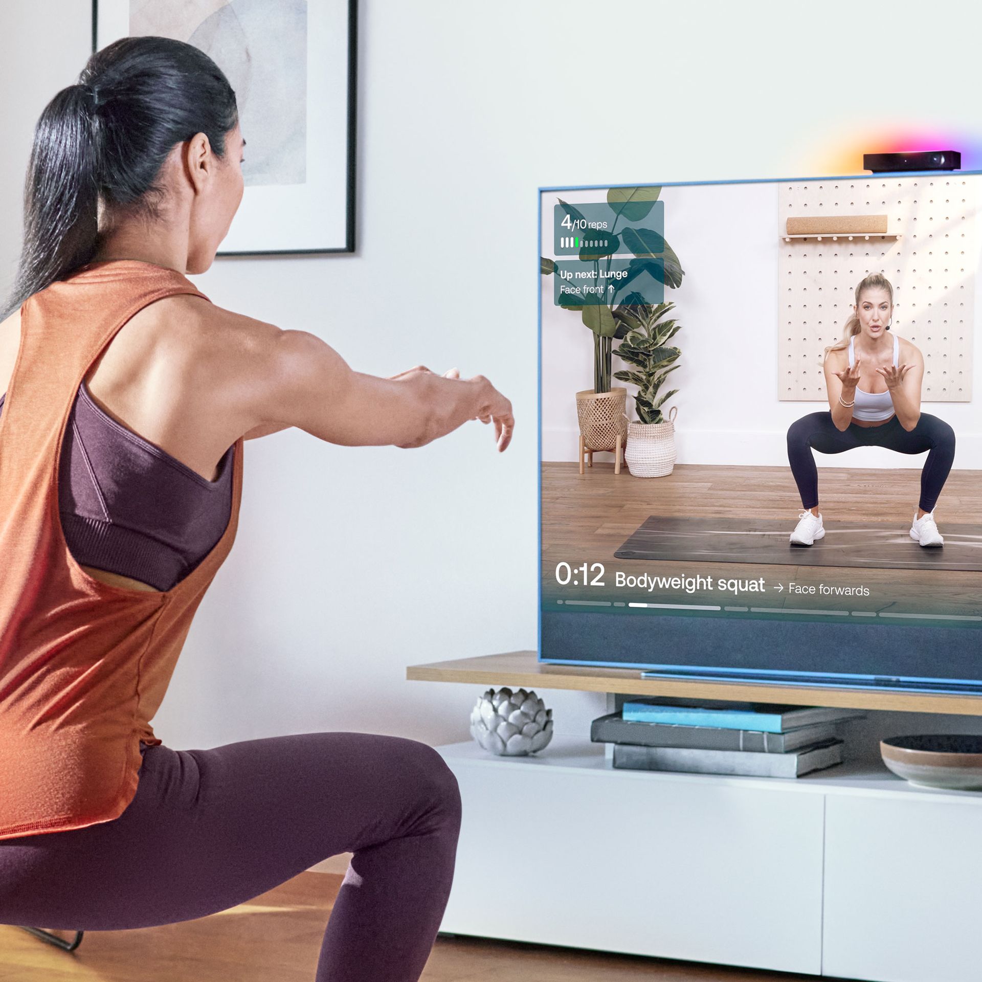 Sky Glass with Sky Live device with a woman using the workout fucntionality
