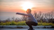 Woman doing a squat outside