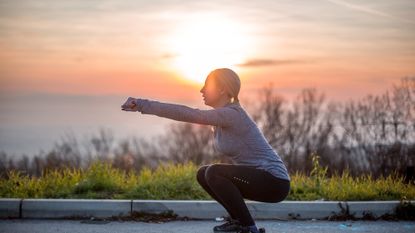 Woman doing a squat outside