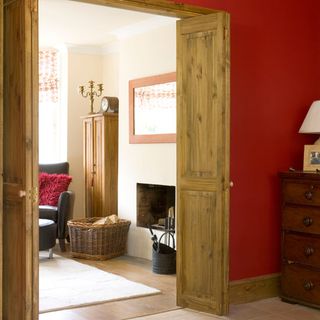 room with wooden floor and red wall and Rustic folding doors