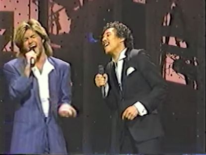 George Michael and Smokey Robinson sing "Careless Whisper" in 1985
